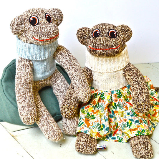 Red Rufus SockMonkeys in jumpers and a skirt. Handmade in Ireland.