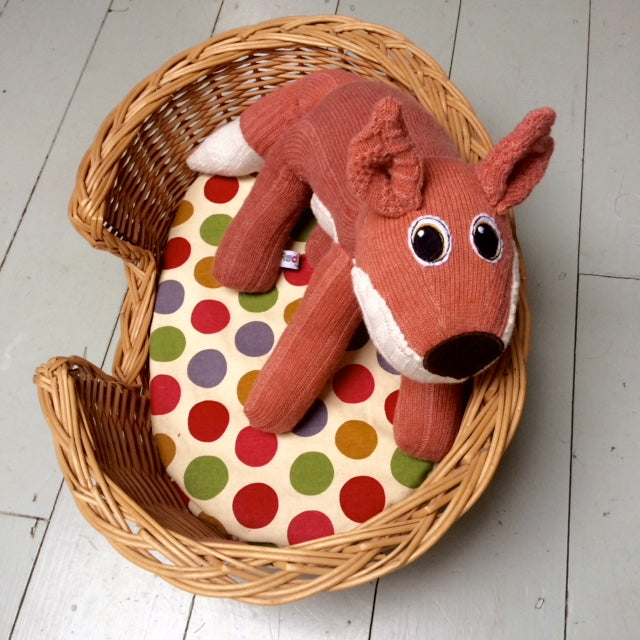 Ferfus SockFox made from a pair of socks, he's curled up in his basket | Red Rufus SockFox